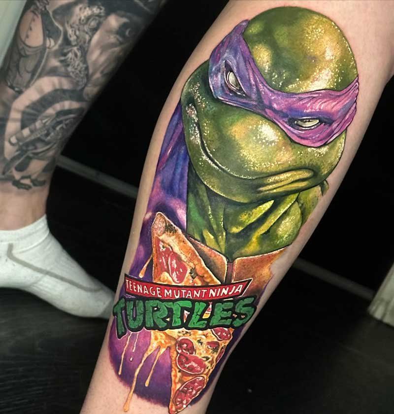 A tattoo of a teenage mutant ninja turtle holding a slice of pizza